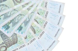 10 Croatian kuna bills lies isolated on white background with copy space stacked in fan shape close up photo