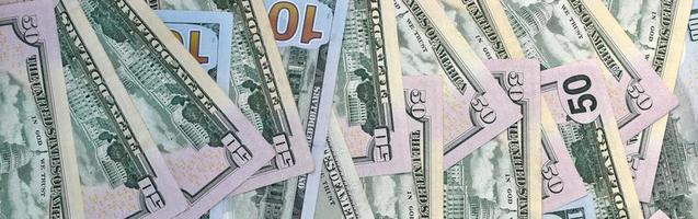 Many one hundred and fifty dollar bills on flat background surface close up. Flat lay top view photo