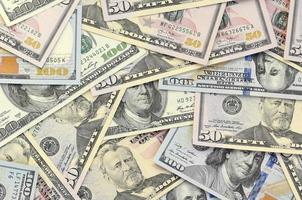 Many one hundred and fifty dollar bills on flat background surface close up. Flat lay top view photo