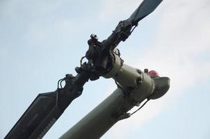 Tail rotor of armoured military helicopter close up against blue sky background photo