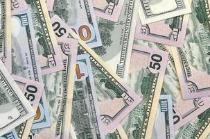 Many one hundred and fifty dollar bills on flat background surface close up. Flat lay top view photo