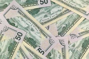 Many US fifty dollar bills on flat background surface close up. Flat lay top view. Abstract business concept photo
