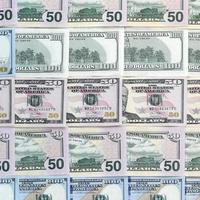 Many one hundred and fifty dollar bills on flat background surface close up. Flat lay top view photo