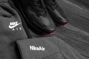 KHARKOV, UKRAINE - DECEMBER 20, 2020 Nike brand clothes and shoes sport wear kit. Nike is American multinational corporation engaged in manufacturing and worldwide marketing of clothes and footwear photo