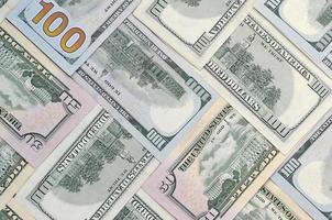 Many one hundred and fifty dollar bills on flat background surface close up. Flat lay top view photo