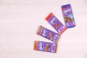 KHARKOV, UKRAINE - DECEMBER 8, 2020 Purple Milka chocolate bars on table. Milka is a Swiss brand of chocolate confection manufactured internationally by company Mondelez International photo