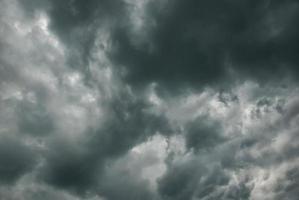 Thunderclouds in stormy sky, dark gray cloudscape before rain photo