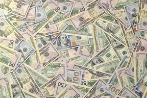Many one hundred and fifty dollar bills on flat background surface close up. Flat lay top view photo
