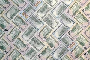 Many one hundred and fifty dollar bills on flat background surface close up. Flat lay top view photo