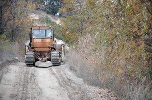 Quarry aggregate with heavy duty machinery. Caterpillar loader Excavator with backhoe driving to construction site quarry photo