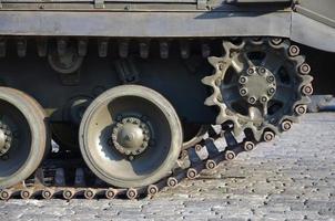 Close up of green armoured caterpillar transport. Modern military transportation vehicle technologies photo