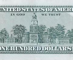 Independence Hall on 100 dollars banknote back side closeup macro fragment. United states hundred dollars money bill photo