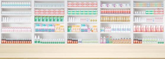 Empty wood counter top with pharmacy drugstore shelves blur pharmaceutical background photo