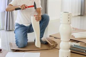 Man assembling furniture at home photo