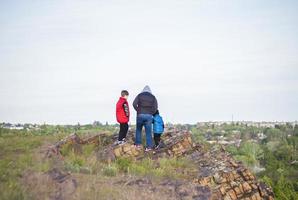 A man and children are standing on a rock and watching what is happening below. panoramic view from above. Russia, Rostov region, skelevataya skala, the 7th wonder of the Don world. photo