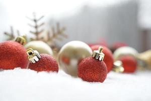 Christmas decoration. Christmas spruce with ball and blurred shiny lights. Christmas composition is with colorful balls on snow. Christmas decoration on snow with blur abstract background photo