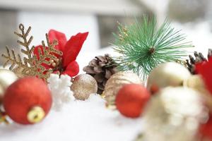 Christmas decoration. Christmas spruce with ball and blurred shiny lights. Christmas composition is with colorful balls on snow. Christmas decoration on snow with blur abstract background photo