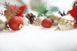 Christmas decoration. Christmas spruce with ball and blurred shiny lights. Christmas composition is with colorful balls on snow. Christmas decoration on snow with blur abstract background photo