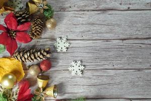 Red and gold Christmas ornament corner border banner. Above view on a rustic wood background. photo