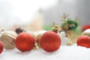 Christmas decoration. Christmas spruce with ball and blurred shiny lights. Christmas composition is with colorful balls on snow. Christmas decoration on snow with blur abstract background photo