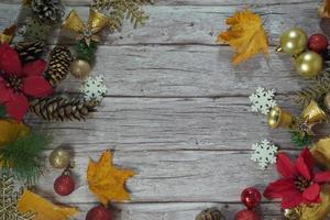 Red and gold Christmas ornament corner border banner. Above view on a rustic wood background. photo