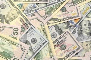 Many one hundred and fifty dollar bills on flat background surface close up. Flat lay top view photo