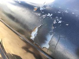 The paint sheet on the outside surface of the car is cracked into various shapes according to the condition and time of use of the car photo