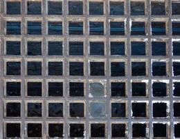 Checkered lattice. The texture of the old building. Lattice of a   abandoned building photo