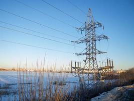 Power line. Pillar. Metal tower. Electricity in the city. photo