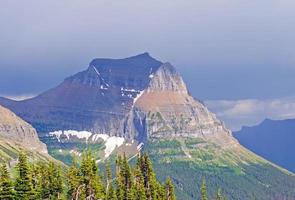 Mountain coming out of storm clouds photo