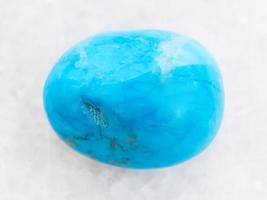 polished Turquenite blue howlite stone on white photo