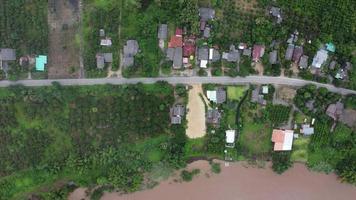 Aerial view of the river flowing after heavy rain and flooding of fields in rural villages. Top view of agricultural areas affected by rainy season floods. Climate change concept video