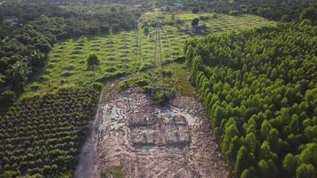Aerial view of high voltage pylon foundation construction site in rural. Top view of high voltage power poles and wires at sunset in the countryside. video