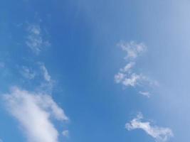 Blue sky with puffy clouds background photo