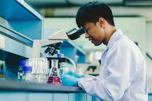 Asian male medical or scientific researcher or doctor Working in The Laboratory.Advanced Scientific Lab for Medicine, Biotechnology, Microbiology Development