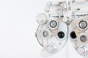 Selective focus at Optometry frame equipment. With blurred white background for copy space. Optometrist tool to examine eye visual system of patient with professional machine before made glasses. photo