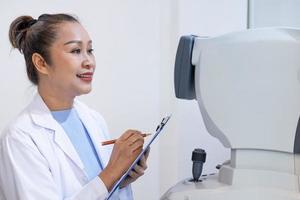 Selective focus at screen of Optometry equipment. While optometrist using subjective refraction to  examine eye visual system of young men patient with professional machine before made glasses. photo