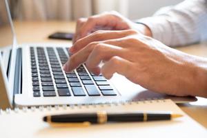 Selective focus at Asian men hand while type on computer keyboard and study online learning class at home. Social distance concept new normal lifestyle that people can work  or do home school. photo