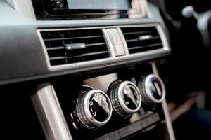 Salesperson adjusts the car air conditioner photo