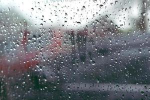 Wet mirror with defocused reflections and blurred background. Rain dropped. Selective focus. photo