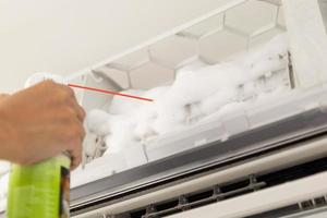 air conditioner cleaning with spray foam cleaner photo