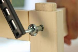 Assembly wooden furniture at home using screw allen photo