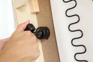 Man assembling sofa furniture at home photo