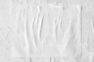 white crumpled and creased paper poster texture background photo