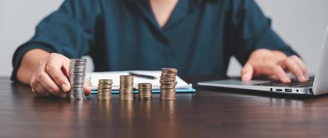 Saving investment banking finance concept. Stack of coins with piggy bank on the table. Growth of loan and investment business idea. Asset Management, Funds, Liabilities, Deposits, Income, Successful. photo