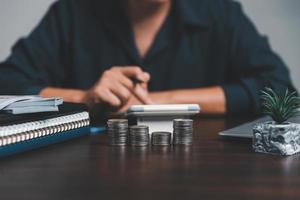 Saving investment banking finance concept. Stack of coins with piggy bank on the table. Growth of loan and investment business idea. Asset Management, Funds, Liabilities, Deposits, Income, Successful. photo