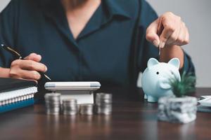 Saving investment banking finance concept. Stack of coins with piggy bank on the table. Growth of loan and investment business idea. Asset Management, Funds, Liabilities, Deposits, Income, Successful. photo