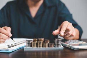 Saving investment banking finance concept. Stack of coins with piggy bank on the table. Growth of loan and investment business idea. Asset Management, Funds, Liabilities, Deposits, Income, Successful. photo