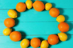 Summer frame of fruit food. Fresh orange lemon on blue wooden background. Mock up. Top view and copy space photo