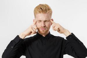 Young man in thinking process. Close up redheaded guy with red beard in black shirt focus on creating startup idea isolated on gray background. Intellect mind and brain power. Mental health photo